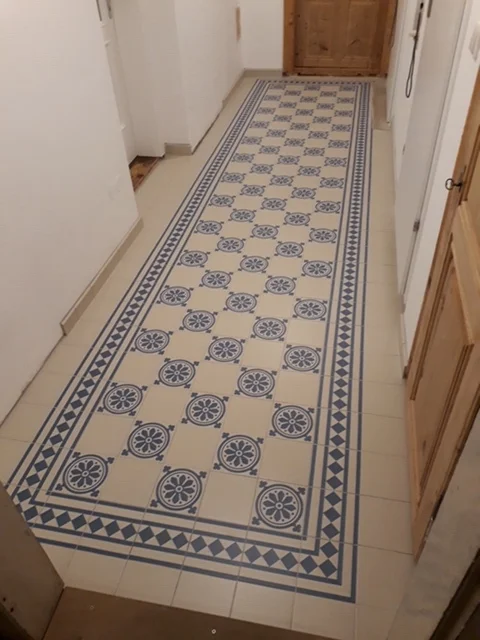 Hallway with a historic tile pattern in blue and beige