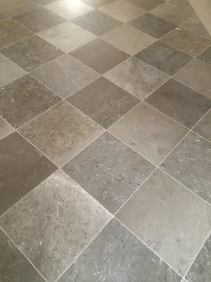 Aurisina shell limestone from Trieste, natural stone slabs laid diagonally.