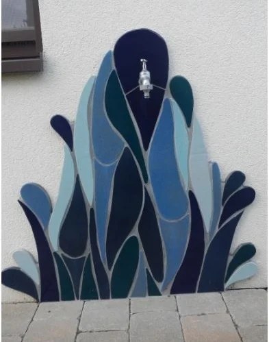 Handmade, one-of-a-kind ceramics as a splash guard for an outdoor tap – frost-proof.